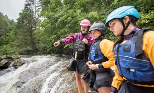 Three females scouting the rapids
